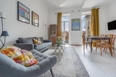 a living room with two couches and a dining room at Mer et Soleil - Carré d'or - 4 piéces - Centre ville - Plages à 300 m in Nice