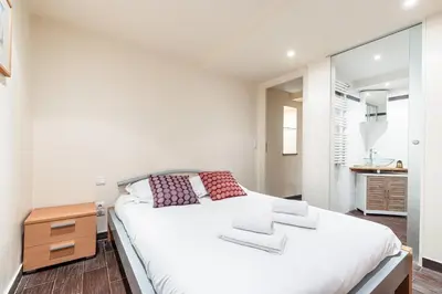 a bedroom with a large white bed and a mirror at Atypical Cozy 1 Bdr Old Town in Nice