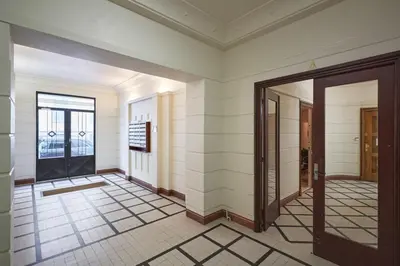 a hallway with a door and a tile floor at Sunlight Properties - Daffia - Beautifully renovated studio, city pad in Central Nice in Nice