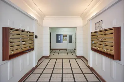 a hallway with wooden doors and a tile floor at Sunlight Properties - Daffia - Beautifully renovated studio, city pad in Central Nice in Nice