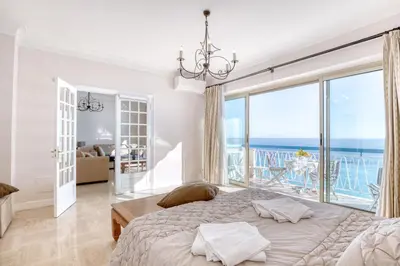 a bedroom with a bed and a large window at Horizon Blue Lux Apartment in Nice