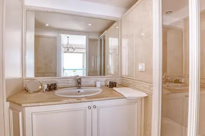 a bathroom with a sink and a mirror at Horizon Blue Lux Apartment in Nice