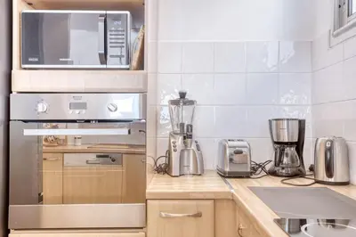 a kitchen with a stove top oven next to a counter at Horizon Blue Lux Apartment in Nice