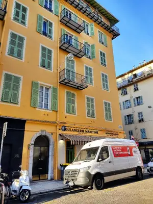 a van parked in front of a yellow building at 2 à 6 personnes - WELCOME TO NICE ! LOGEMENT PORT in Nice