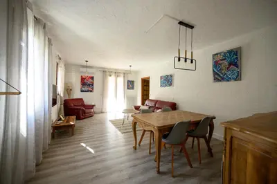 a living room with a wooden table and chairs at LA CASA in Cagnes-sur-Mer
