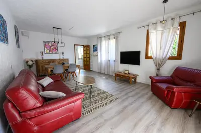 a living room with two red couches and a television at LA CASA in Cagnes-sur-Mer