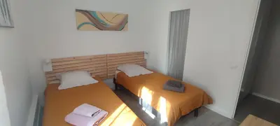 two beds in a small room withermottermottermott at LA CASA in Cagnes-sur-Mer
