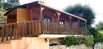 a wooden house with a balcony on top at Le Chalet de la Pierreraie Côte d'Azur Piscine Terrasse et Vue Mer in Drap
