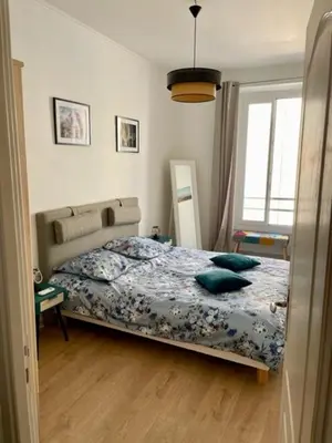 a bedroom with a bed with blue pillows on it at Un havre de paix et de calme en plein centre de Massena in Nice