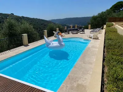 a swimming pool with a inflatable swan in the water at Villa avec piscine chauffée Nice collines in Nice