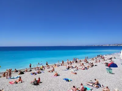 a group of people sitting on a beach at Villa avec piscine chauffée Nice collines in Nice