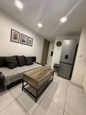 a living room with a couch and a coffee table at Jolie appartement Nice proche mer et aéroport Une chambre plus salon avec cuisine in Nice