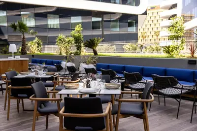 a restaurant with tables and chairs on a rooftop at Sheraton Nice in Nice