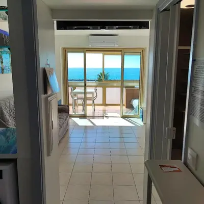 a view of a room with a view of the ocean at Grand studio bord de mer- accès direct aux plages in Saint-Laurent-du-Var
