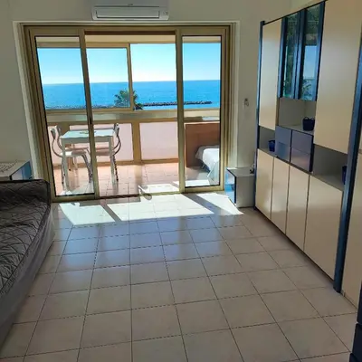 a living room with a view of the ocean at Grand studio bord de mer- accès direct aux plages in Saint-Laurent-du-Var