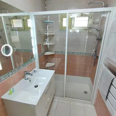 a bathroom with a shower and a white sink at Grand studio bord de mer- accès direct aux plages in Saint-Laurent-du-Var