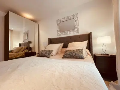 a bedroom with a large bed with two pillows at Nice Renting - PAGANINI - Spacious Apartment - 2 BedRooms - King Bed - Bathtub - Heart of Nice in Nice