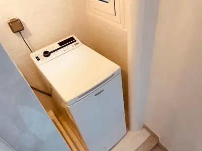 a small white refrigerator in a corner of a room at Nice Renting - PAGANINI - Spacious Apartment - 2 BedRooms - King Bed - Bathtub - Heart of Nice in Nice