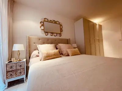 a bedroom with a large bed and a mirror on the wall at Nice Renting - PAGANINI - Spacious Apartment - 2 BedRooms - King Bed - Bathtub - Heart of Nice in Nice