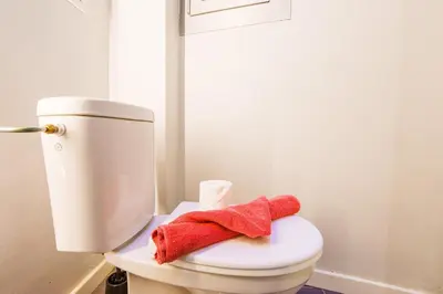 a red stuffed animal sitting on top of a toilet at LE TIVOLI AP4264 By Riviera Holiday Homes in Nice