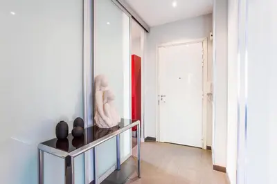 a room with a mirror and a table with vases on it at LE TIVOLI AP4264 By Riviera Holiday Homes in Nice