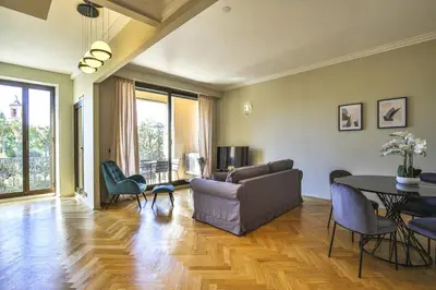 a living room with a couch and a table and chairs at Balcon vue Coulée Verte. Luxe Plein cœur de Nice in Nice