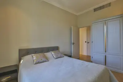 a bedroom with a large bed and a closet at Balcon vue Coulée Verte. Luxe Plein cœur de Nice in Nice