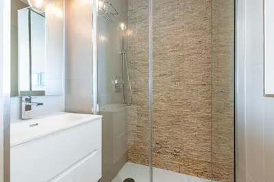 a bathroom with a glass shower and a sink at Villefranche Sur Mer:Appartement-villa, Vue mer, jardin, parking. in Villefranche-sur-Mer