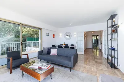 a living room with a couch and a table at Villefranche Sur Mer:Appartement-villa, Vue mer, jardin, parking. in Villefranche-sur-Mer