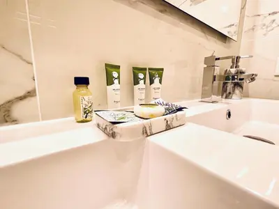 a white bathroom with a sink and a mirror at Reine Marie :Top floor Carré d'or avec accès direct à la mer in Nice