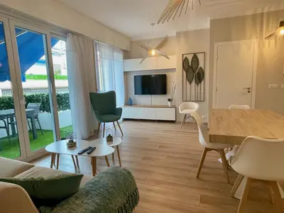 a living room with a table and a dining room at Reine Marie :Top floor Carré d'or avec accès direct à la mer in Nice
