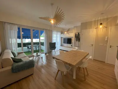 a living room with a table and a couch at Reine Marie :Top floor Carré d'or avec accès direct à la mer in Nice