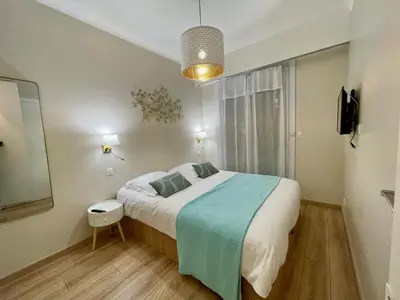 a bedroom with a large bed and a mirror at Reine Marie :Top floor Carré d'or avec accès direct à la mer in Nice