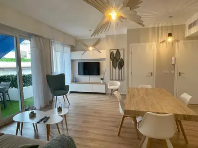 a living room with a table and a dining room at Reine Marie :Top floor Carré d'or avec accès direct à la mer in Nice
