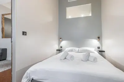 a bedroom with a white bed with white pillows at Charming 2 Bdr Old Town in Nice
