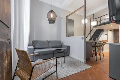 a living room with a couch and a table at Charming 2 Bdr Old Town in Nice