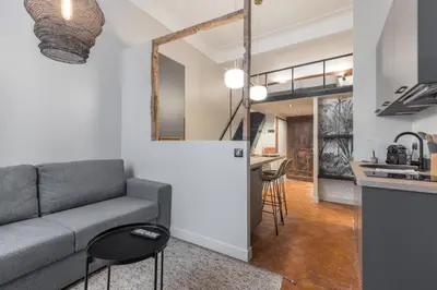 a living room with a couch and a kitchen at Charming 2 Bdr Old Town in Nice