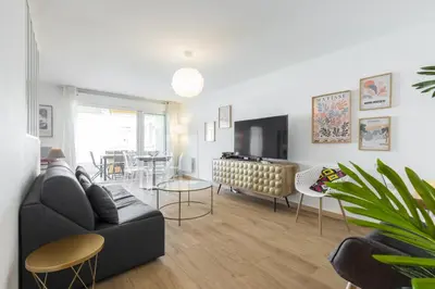 a living room with a couch and a dining room at Large 2 Bdr at Nice Port in Nice