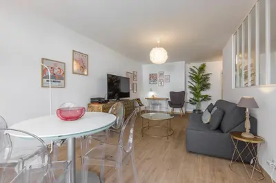 a living room with a couch and a table at Large 2 Bdr at Nice Port in Nice