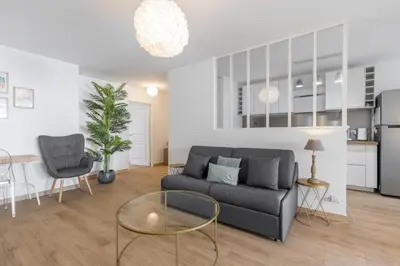a living room with a couch and a table at Large 2 Bdr at Nice Port in Nice