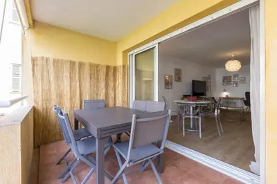 a dining room and living room with a table and chairs at Large 2 Bdr at Nice Port in Nice