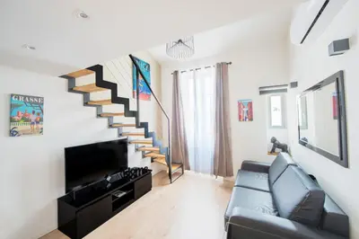 a living room with a couch and a staircase at Central Lamartine Flat - Brand New in Nice