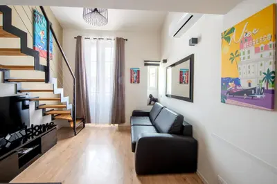 a living room with a couch and a staircase at Central Lamartine Flat - Brand New in Nice