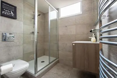 a bathroom with a shower and a toilet and a sink at Central Lamartine Flat - Brand New in Nice