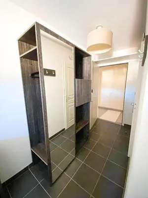 a bedroom with a large bed and a kitchen at City Résidence Nice in Nice