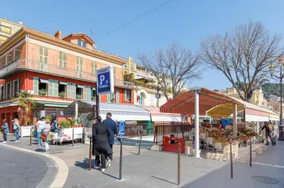 a group of people walking down a street at Maison Bianchi - Old Town Flower market in Nice