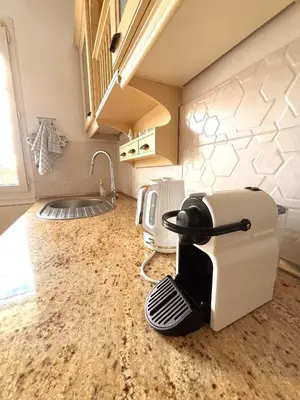 a kitchen with a hair dryer sitting on a counter at Le Nid Blanc Nice Centre in Nice