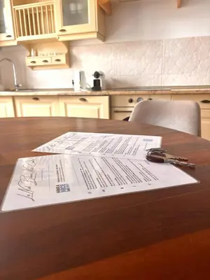 a table with papers on top of a kitchen table at Le Nid Blanc Nice Centre in Nice