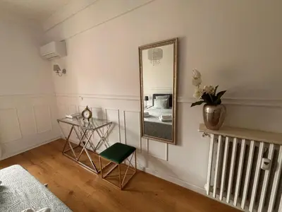 a room with a table and a mirror on the wall at Le Nid Blanc Nice Centre in Nice