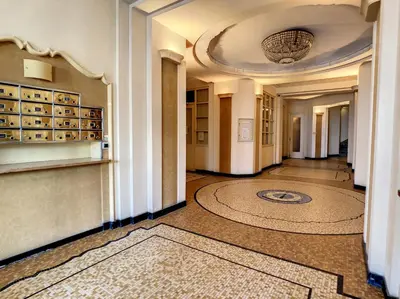 a hallway of a building with a rug on the floor at Nestor&Jeeves - BLUE PROMENADE - Sea front - Central - Luxe in Nice